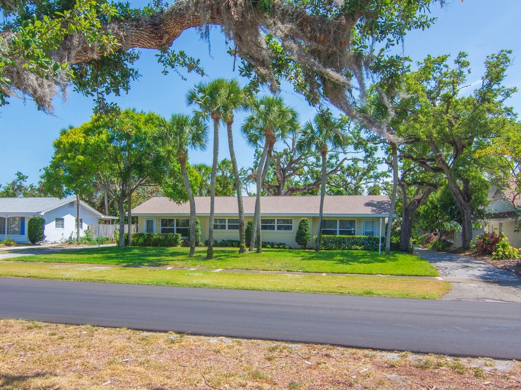 546-556 Azalea Lane Vero Beach, FL 32963 - Photo 14 of 18 a view of swimming pool with lawn chairs and large trees