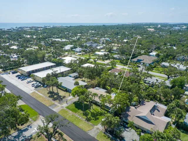 an aerial view of residential houses with city view