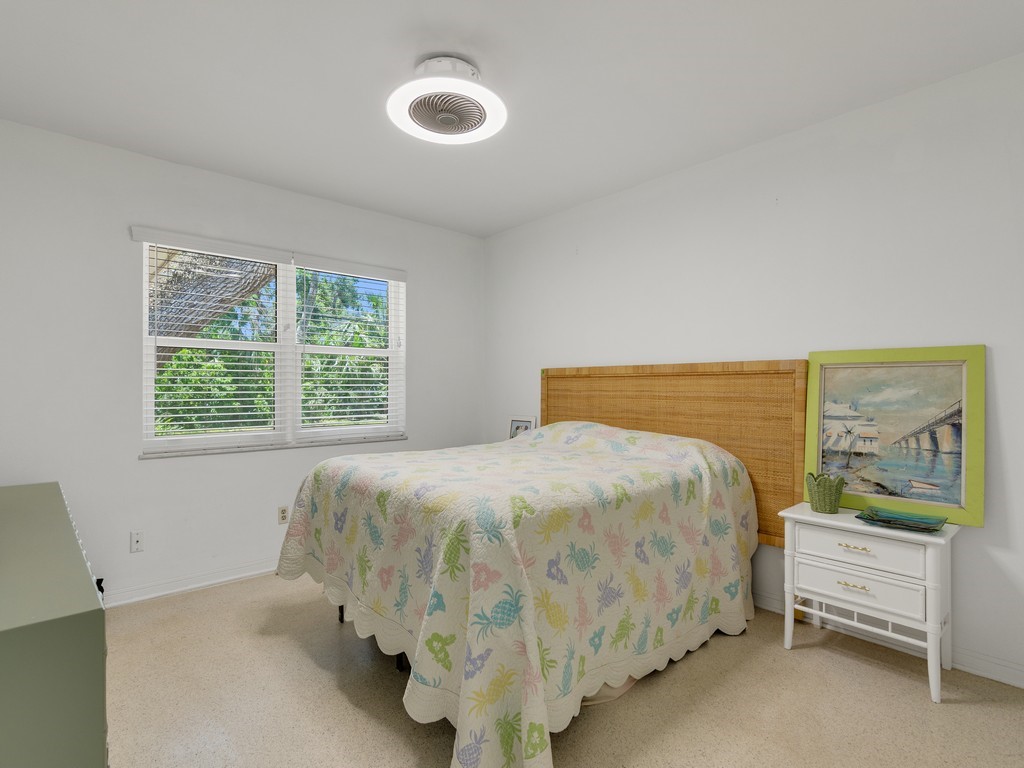 546-556 Azalea Lane Vero Beach, FL 32963 - Photo 9 of 18 a bed sitting in a bedroom next to a window