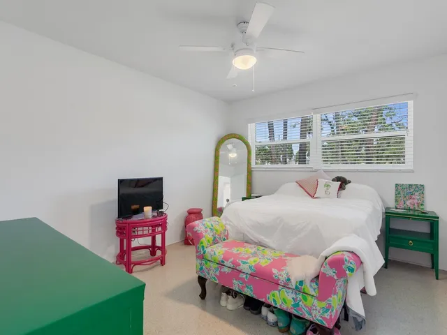 a bedroom with a bed and a dresser in it