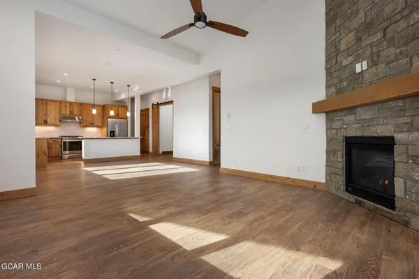 a view of a livingroom with a fireplace and window
