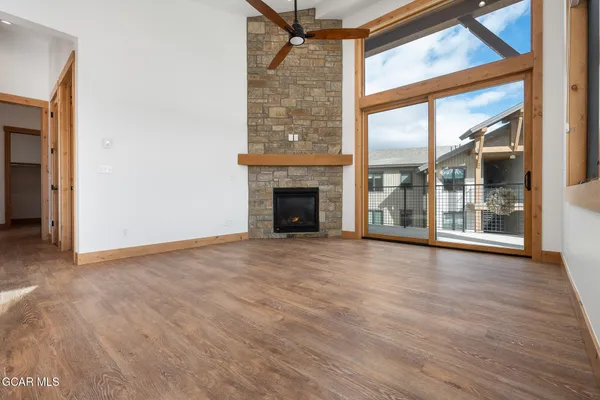 a view of an empty room with glass door and a window