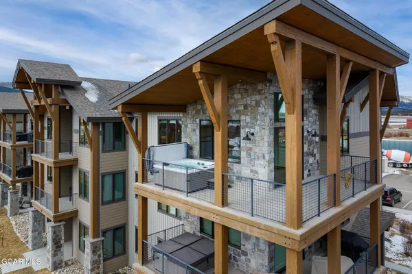 a front view of a building with streets and trees
