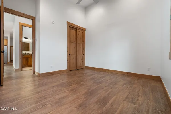 a view of an empty room and wooden floor