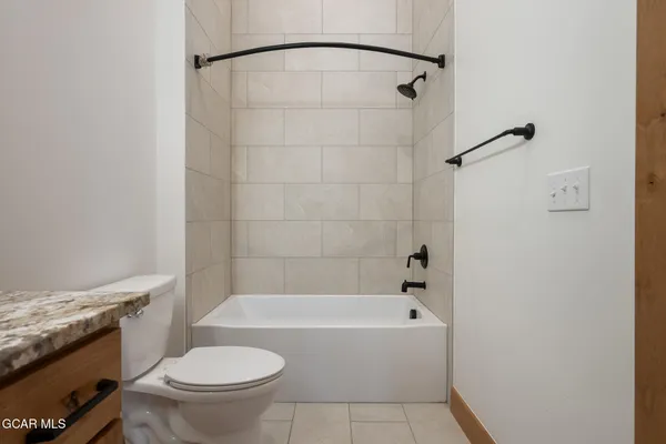 a bathroom with a bathtub and a toilet