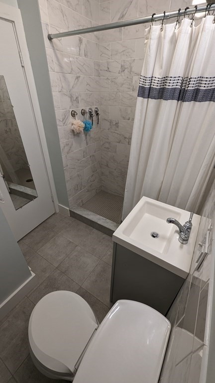 975 Chestnut Street, Unit R Newton, MA 02464 - Photo 8 of 8 a bathroom with a toilet and a shower