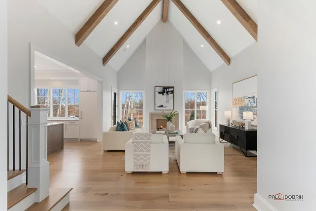 a living room with furniture fireplace and a large window