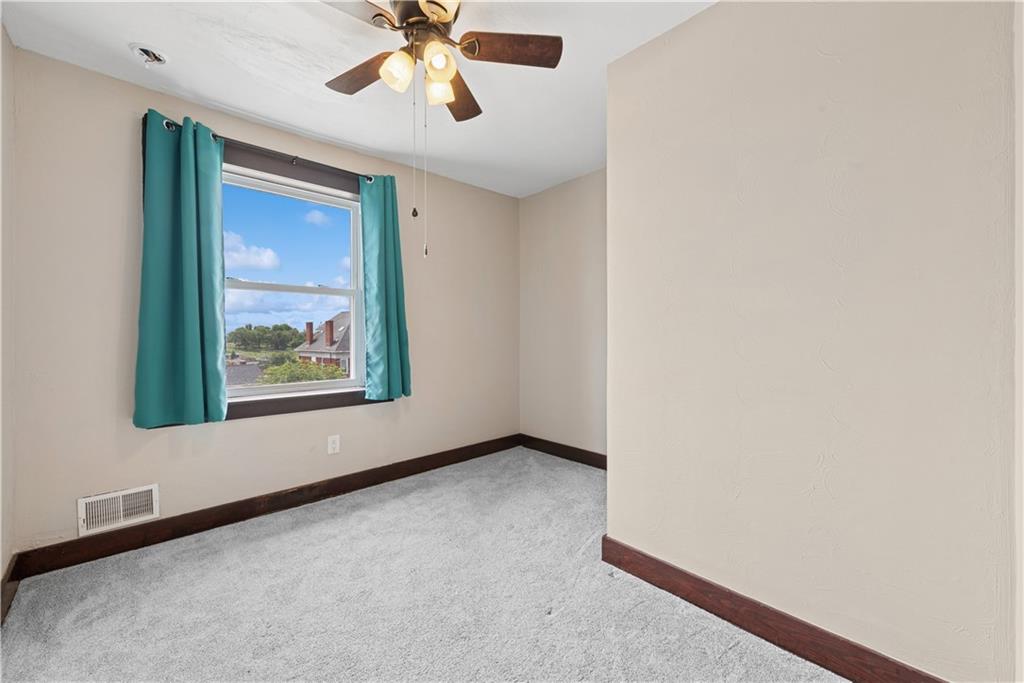 53 Calhoun Avenue Pittsburgh, PA 15210 - Photo 16 of 30 an empty room with window and a chandelier fan