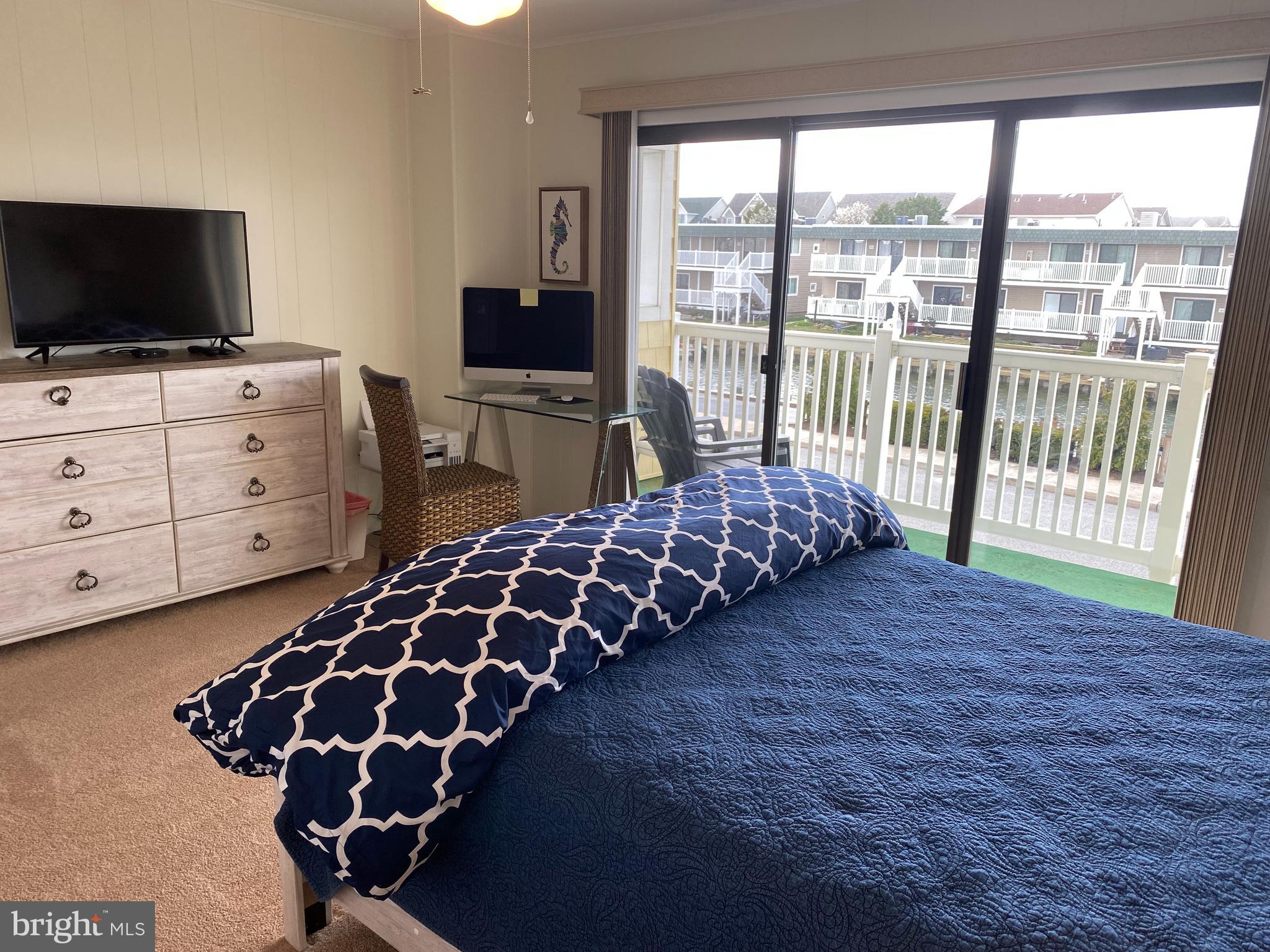 701 Rusty Anchor Road, Unit 15 Ocean City, MD 21842 - Photo 21 of 33 Primary bedroom with canal view. Balcony #2 of 3