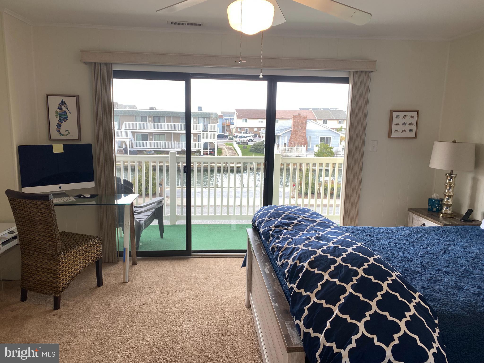 701 Rusty Anchor Road, Unit 15 Ocean City, MD 21842 - Photo 22 of 33 Primary bedroom - View of canal. Balcony #2 of 3