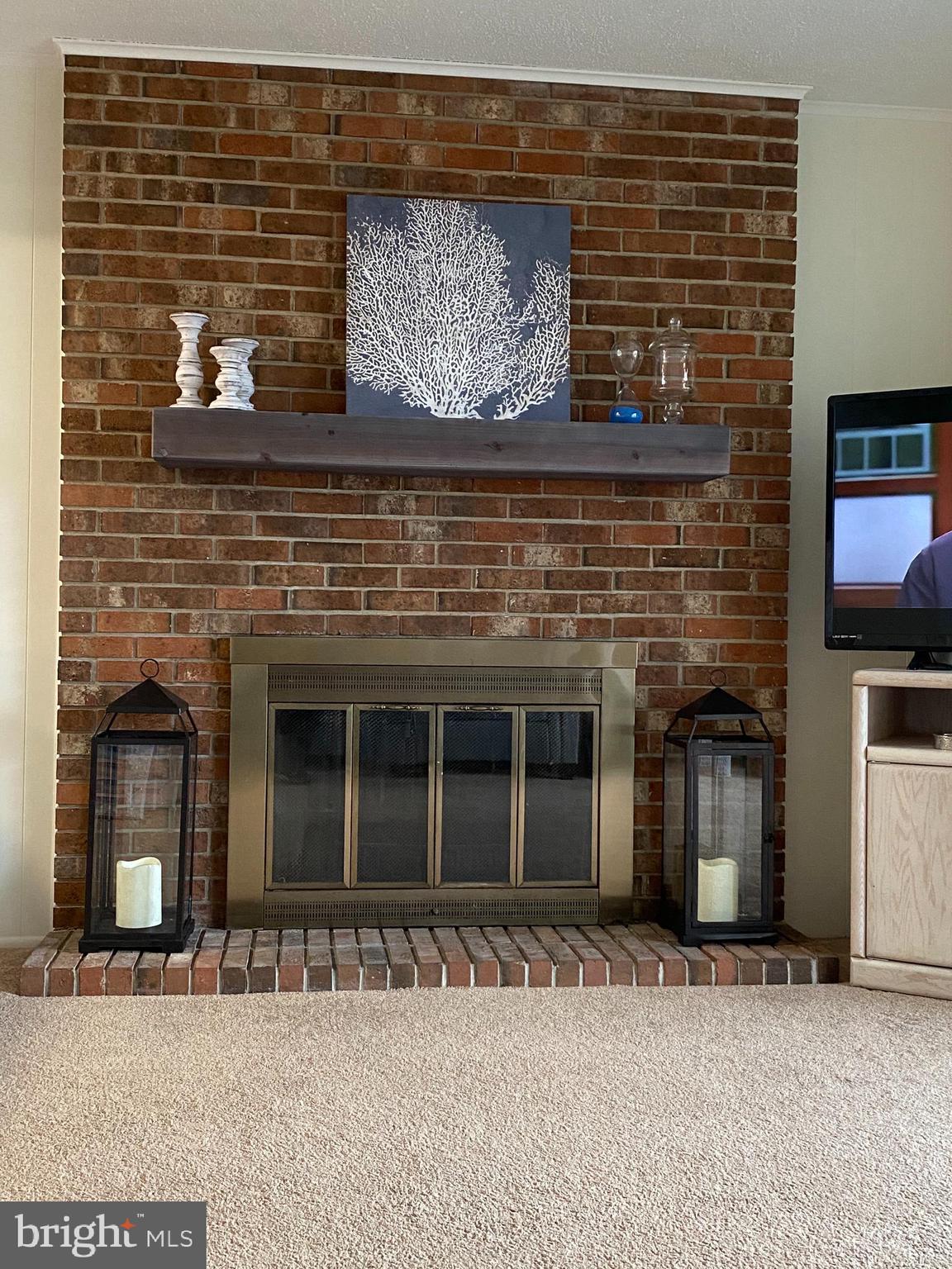 701 Rusty Anchor Road, Unit 15 Ocean City, MD 21842 - Photo 5 of 33 Brick FP with new mantle
