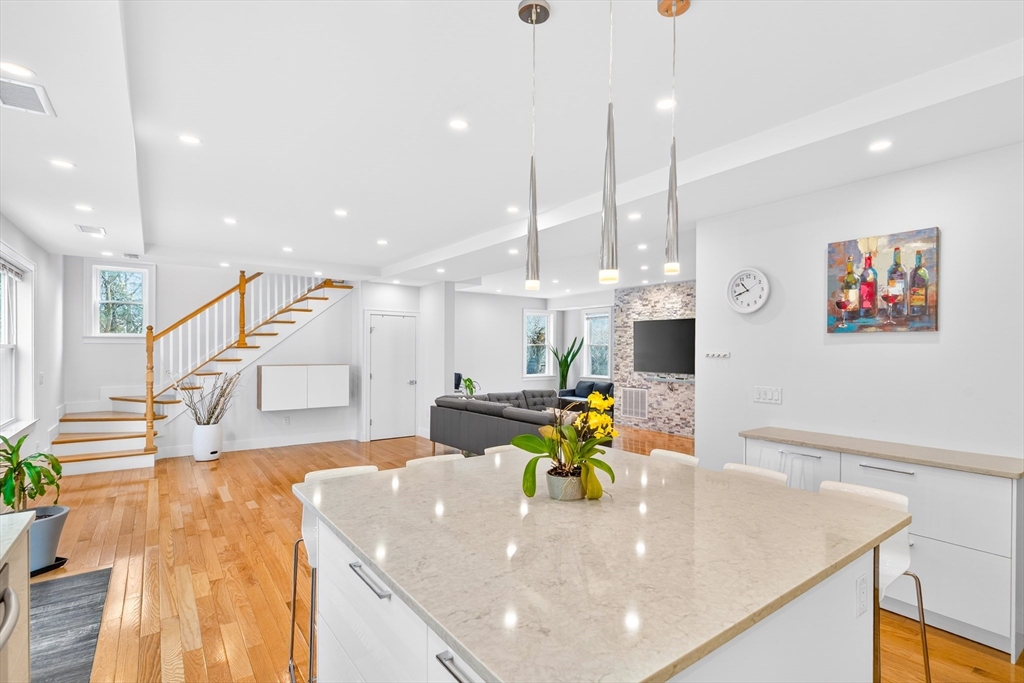93 Alden Street Dedham, MA 02026 - Photo 1 of 41 a large kitchen with a table and chairs