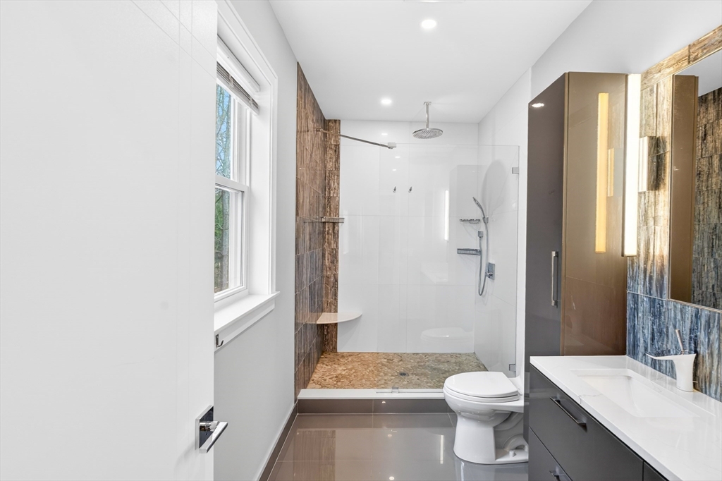 93 Alden Street Dedham, MA 02026 - Photo 13 of 41 a bathroom with a toilet a sink and shower