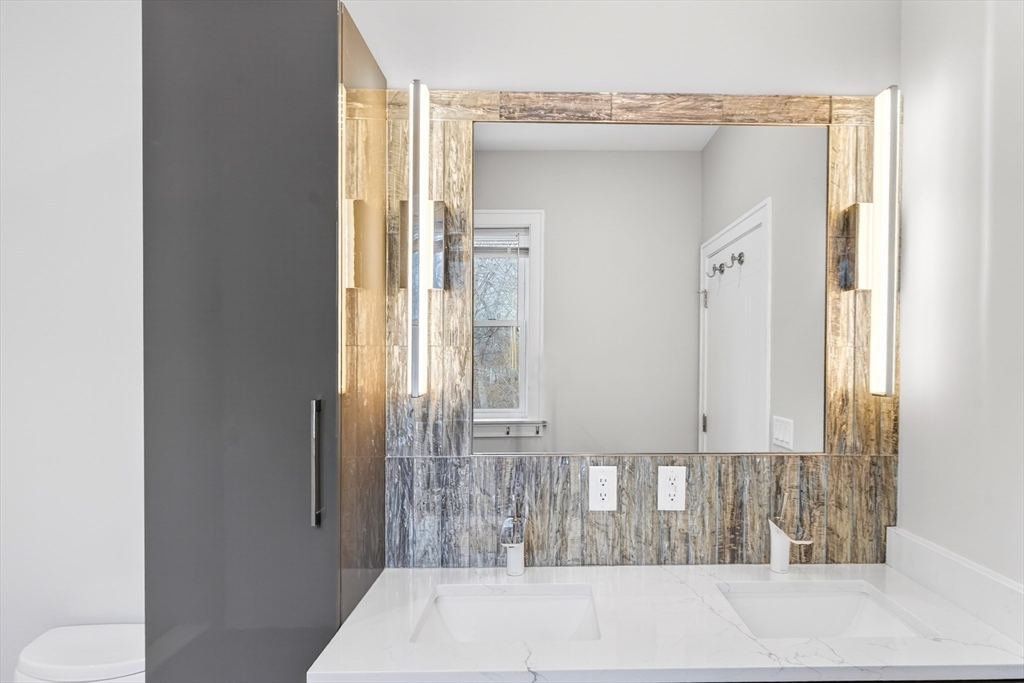 93 Alden Street Dedham, MA 02026 - Photo 15 of 41 a bathroom with a bathtub and a window