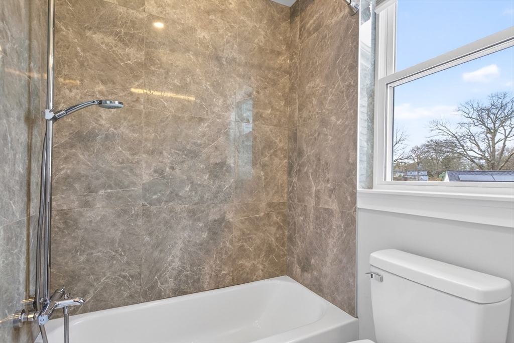93 Alden Street Dedham, MA 02026 - Photo 18 of 41 a bathroom with a shower and a toilet