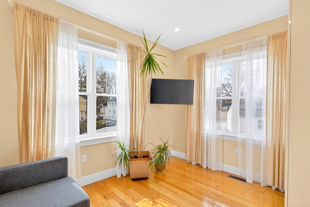 93 Alden Street Dedham, MA 02026 - Photo 19 of 41 a bedroom with a bed and wooden floor