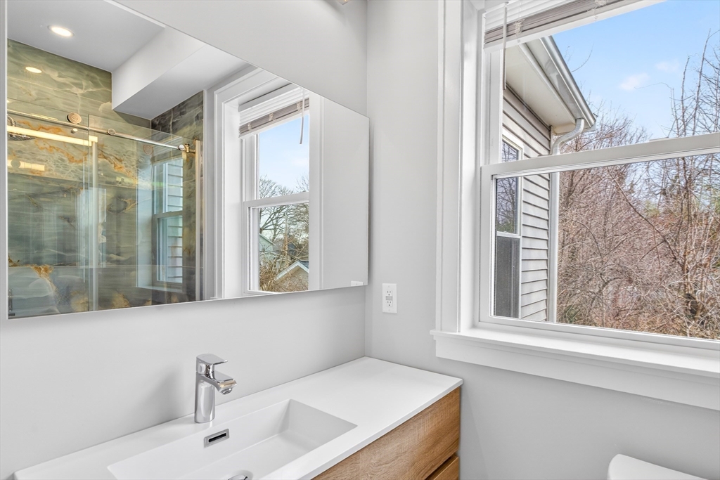 93 Alden Street Dedham, MA 02026 - Photo 29 of 41 a bathroom with a granite countertop sink and a window
