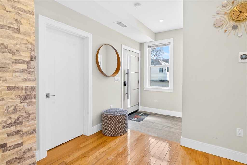 93 Alden Street Dedham, MA 02026 - Photo 9 of 41 a view of a room with wooden floor and white walls