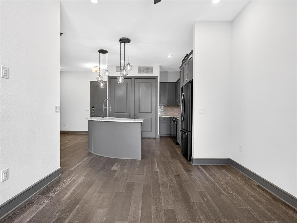 2700 Old Denton Road, Unit 3370 Carrollton, TX 75007 - Photo 8 of 35 a view of a kitchen with wooden floor and electronic appliances