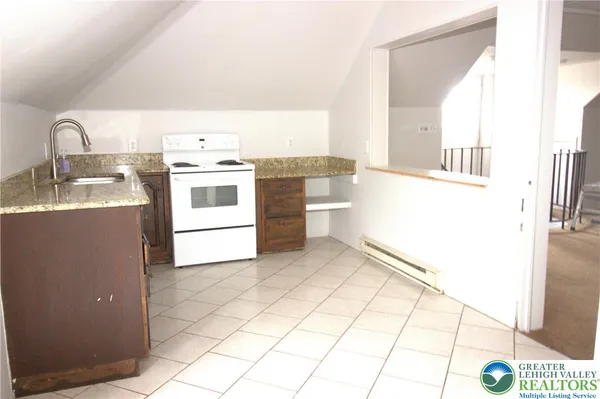 a kitchen with a sink a stove and a microwave