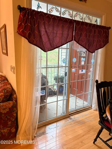 a view of entryway with wooden floor and door