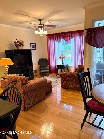 a living room with furniture a fireplace and a chandelier