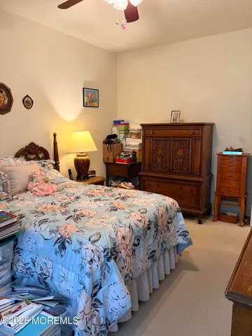 a bedroom with a bed and dresser with chair