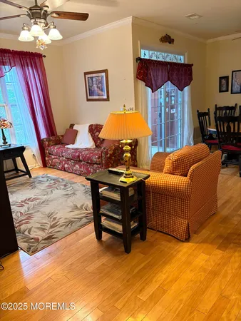 a living room with furniture a chandelier and a large window