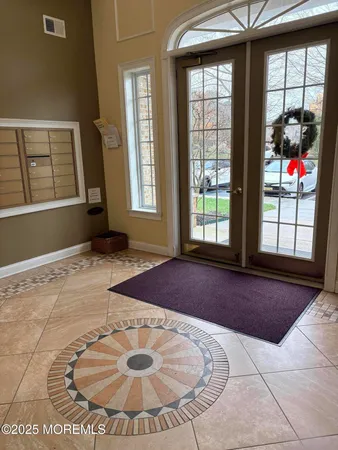 a living room with furniture fireplace and a large window