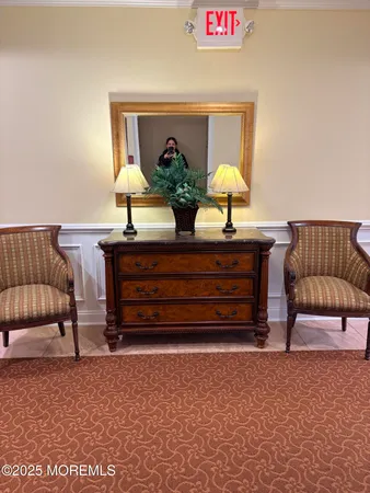 a living room with furniture and a air conditioner vent