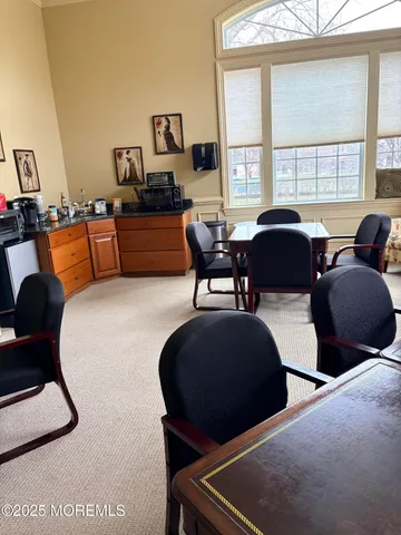 a living room with furniture fireplace and a large window