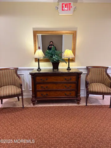 a view of living room with furniture and a lamp