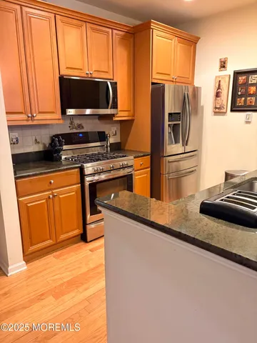 a kitchen with a refrigerator stove and microwave