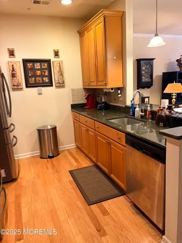 a kitchen with a sink and a stove top oven