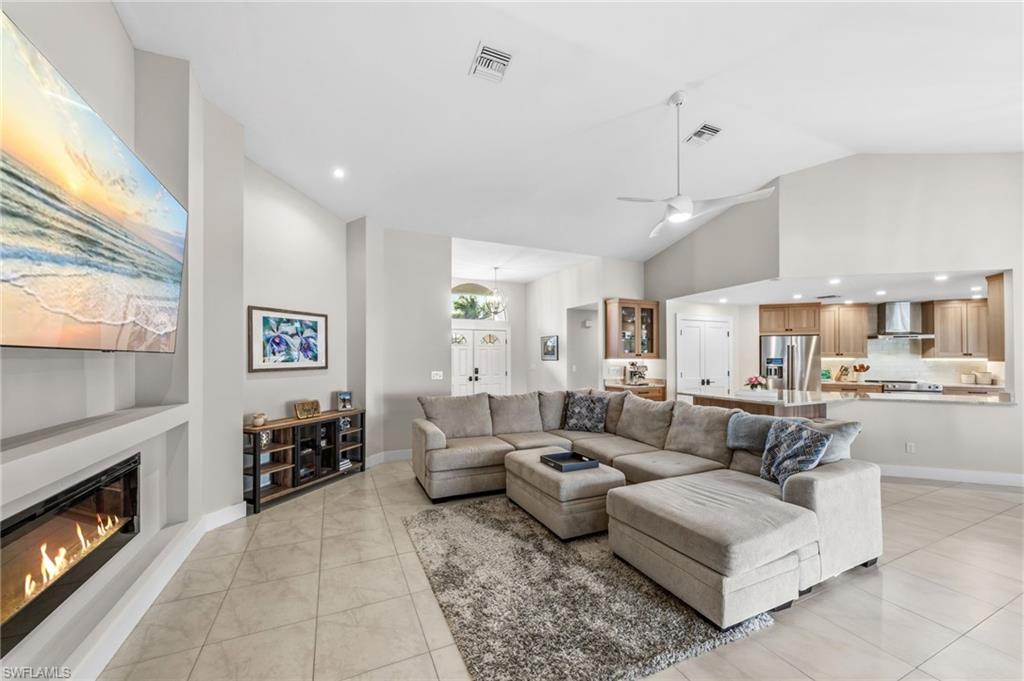 4724 Riverside Drive Estero, FL 33928 - Photo 7 of 44 a large living room with furniture and a fireplace