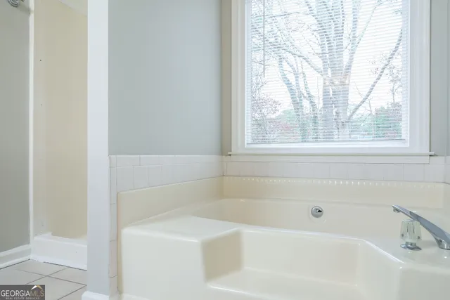 a white bath tub sitting next to a window