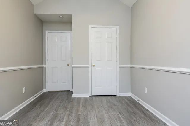 an empty room with wooden floor