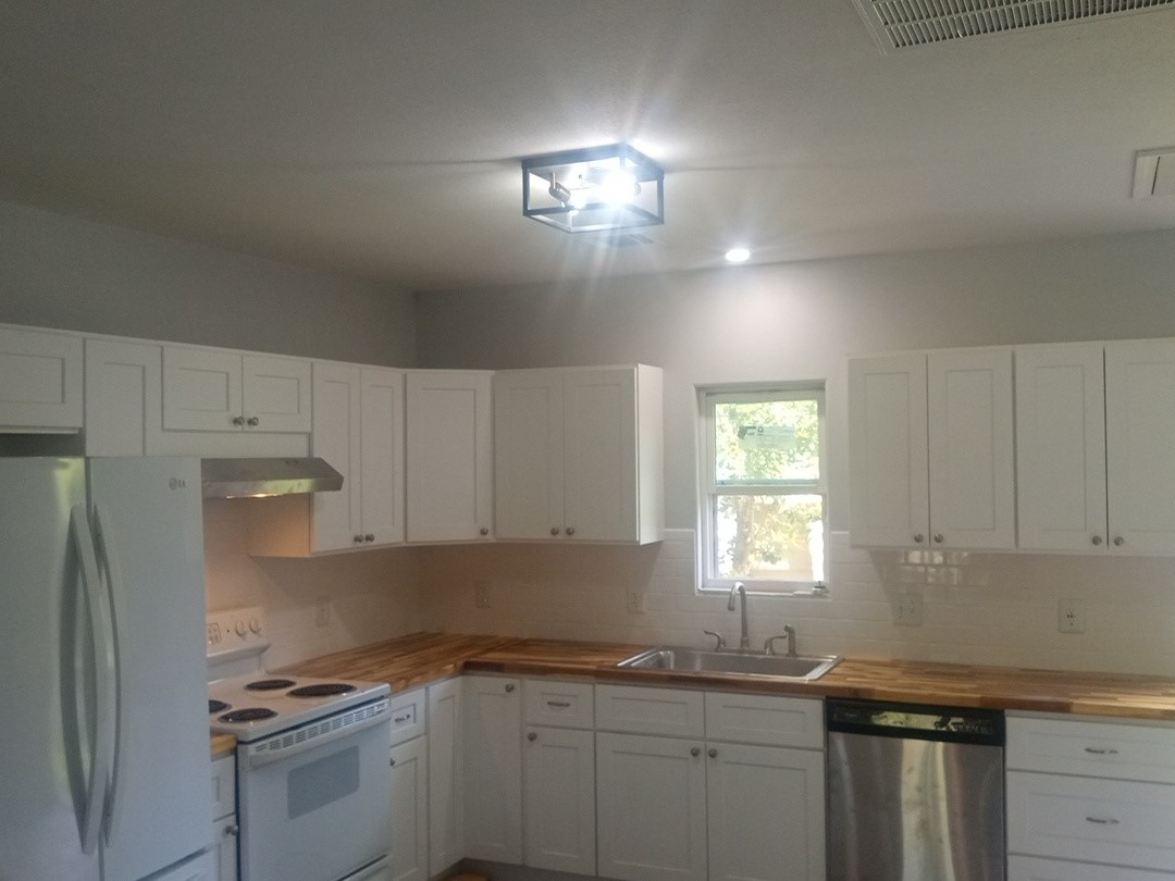 101 Alabama Daisetta, TX 77533 - Photo 2 of 5 a kitchen with a sink stove and cabinets