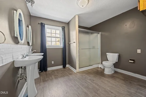 a bathroom with a sink toilet and shower