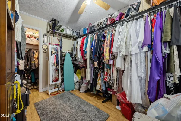 a view of walk in closet with clothes