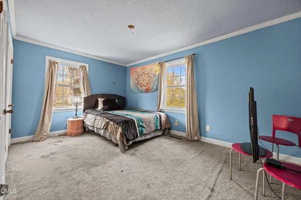 a bedroom with a bed table and window