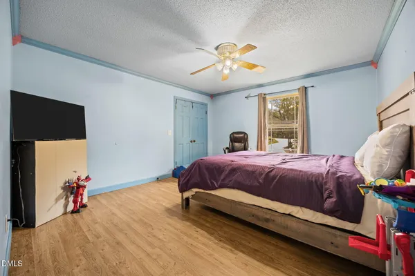 a bedroom with a bed and a chandelier