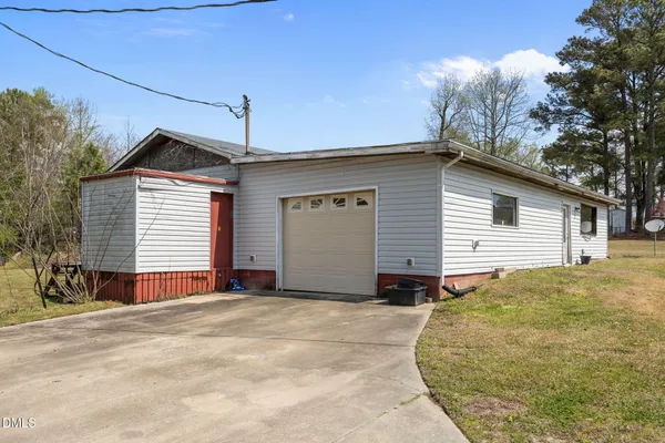 a view of a house with a yard and garage