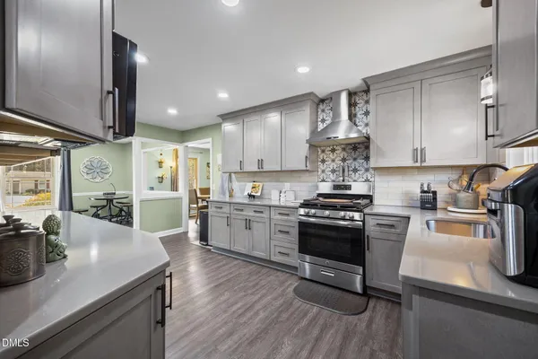 a kitchen with stove and refrigerator