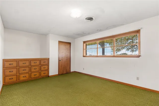a bathroom with a sink a toilet and a window