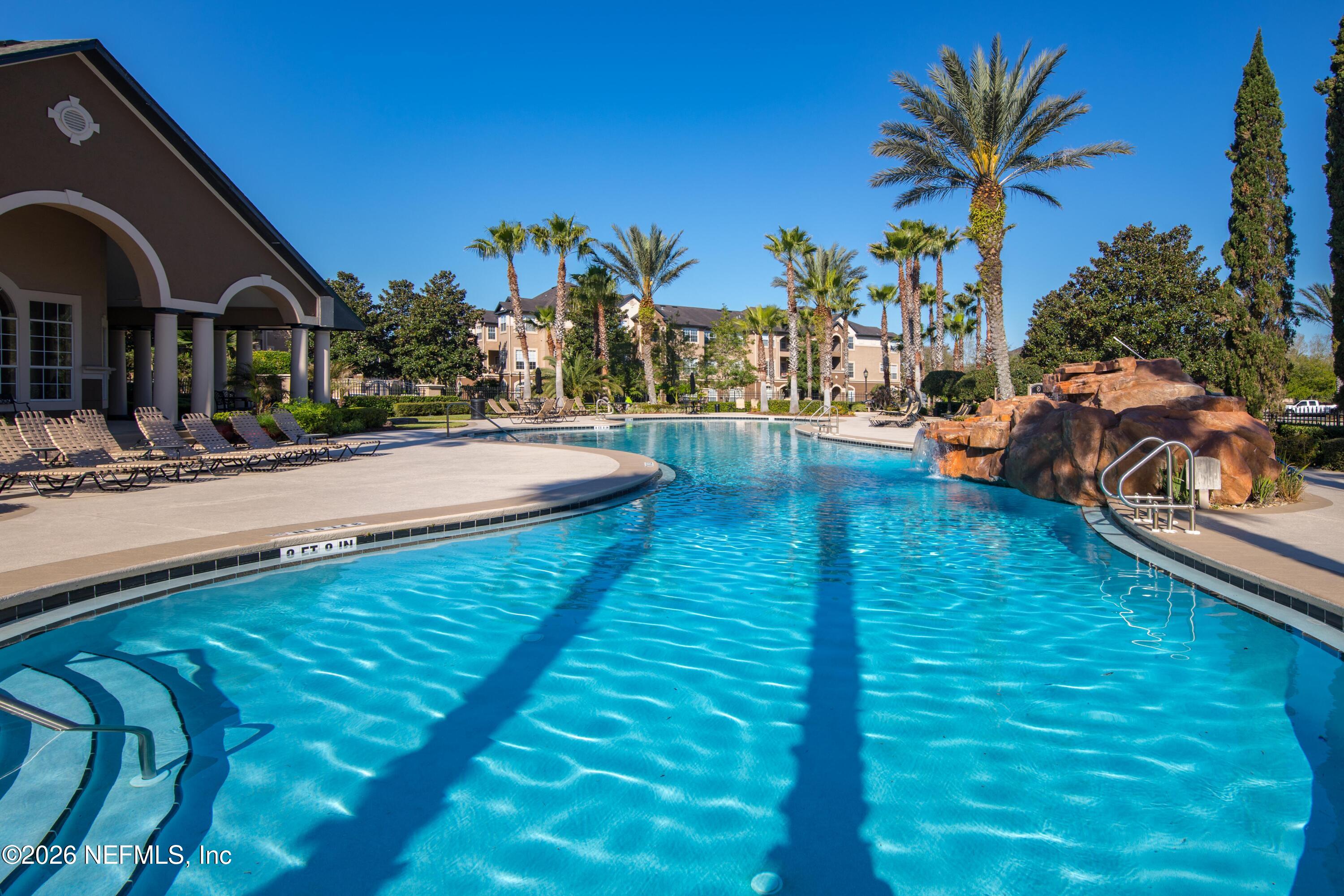 10961 Burnt Mill Road, Unit 225 Jacksonville, FL 32256 - Photo 11 of 17 a swimming pool with outdoor seating and yard