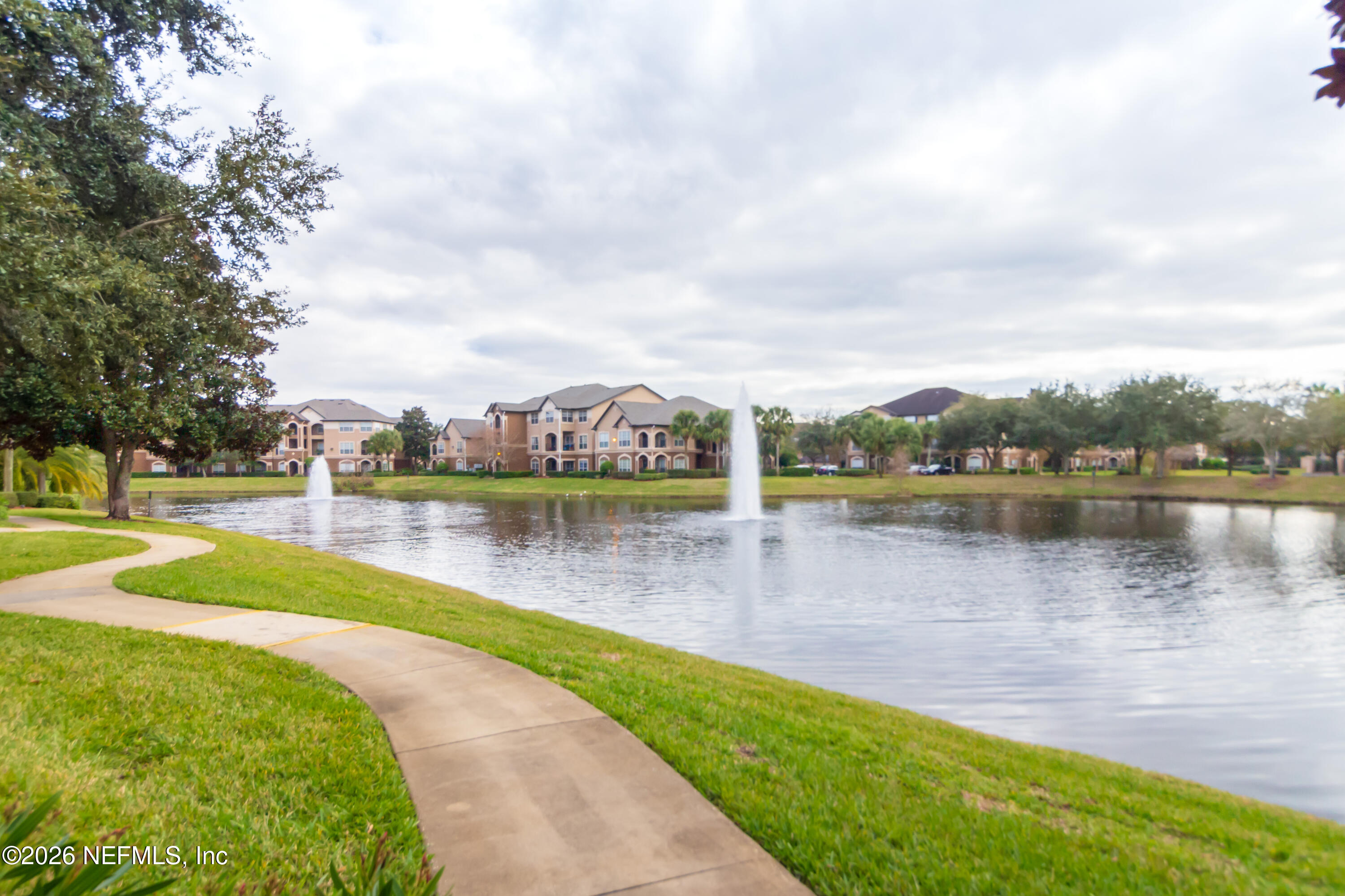 10961 Burnt Mill Road, Unit 225 Jacksonville, FL 32256 - Photo 16 of 17 a view of a lake with houses in the back
