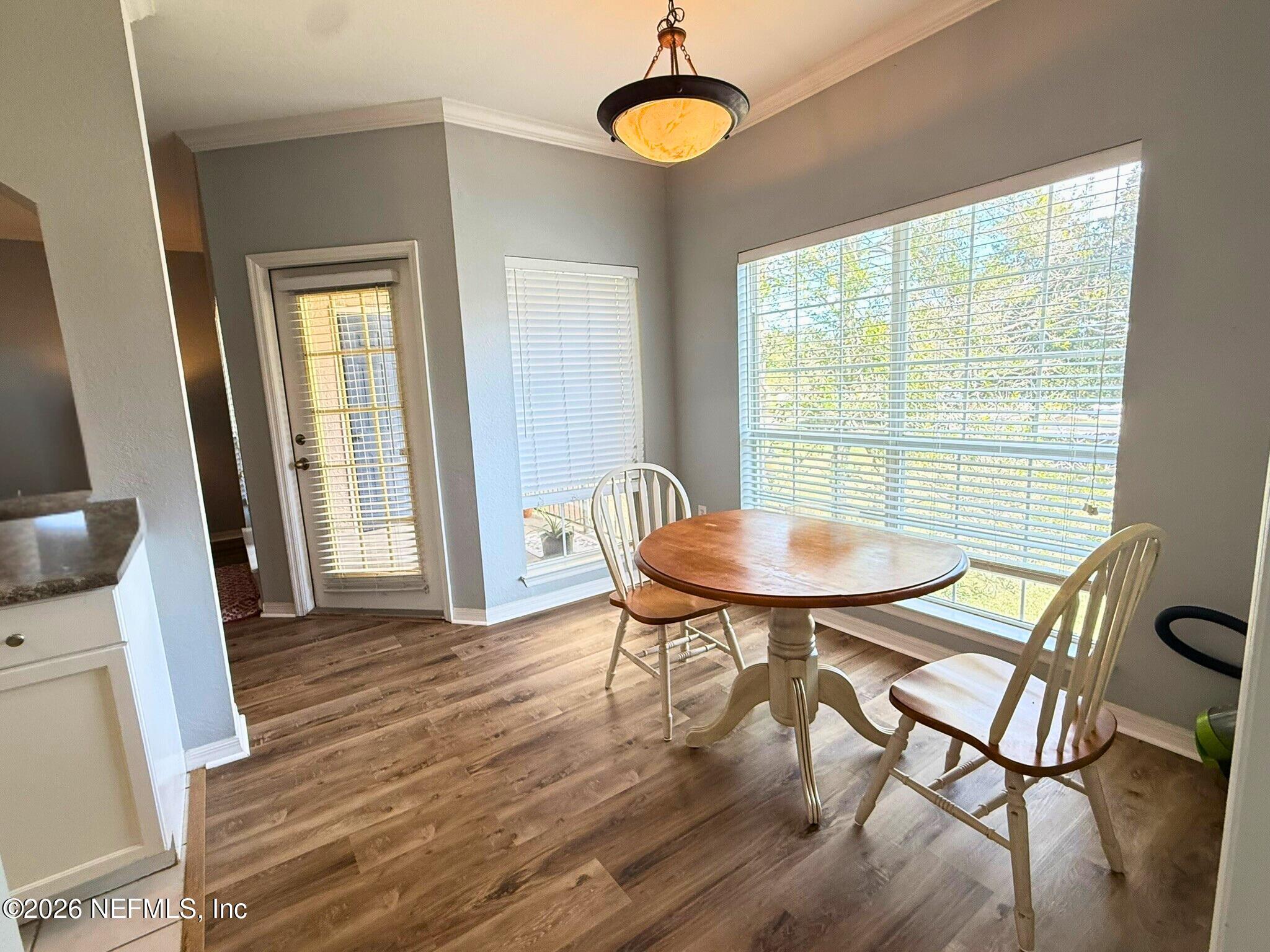 10961 Burnt Mill Road, Unit 225 Jacksonville, FL 32256 - Photo 4 of 17 a view of a dining room with furniture and wooden floor