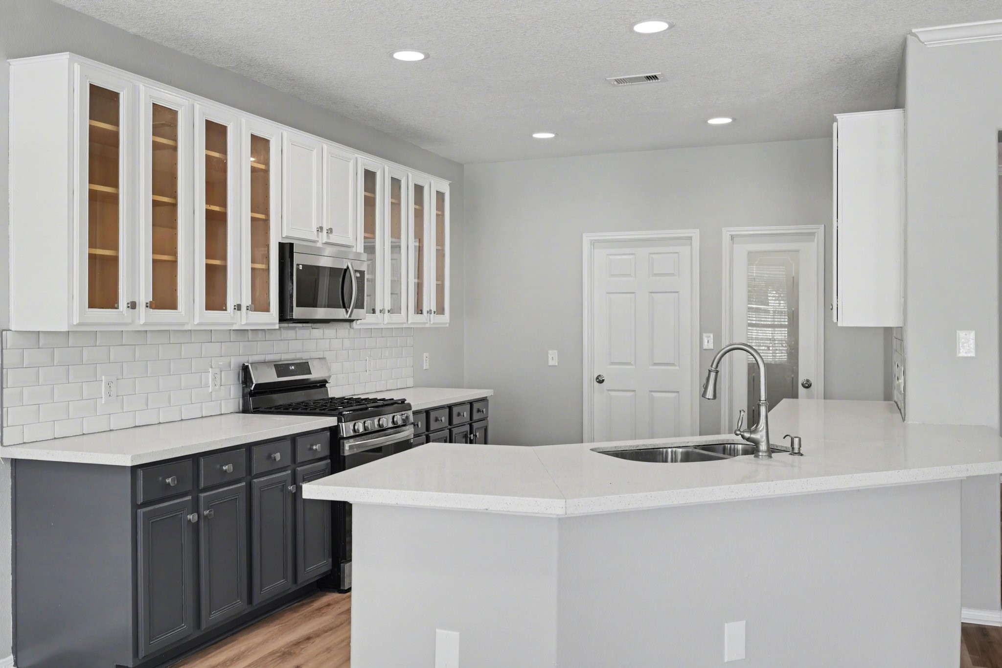 22310 Lamaster Lane Spring, TX 77373 - Photo 15 of 48 A two tone kitchen with wrap around countertop space for all your hosting needs.
