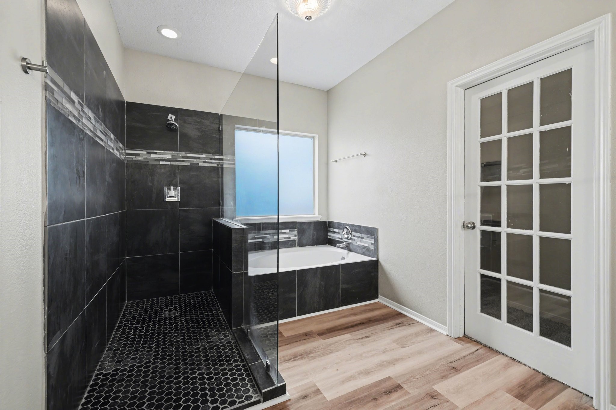 22310 Lamaster Lane Spring, TX 77373 - Photo 28 of 48 Oversized shower and tub in the primary bathroom with walk-in closet.